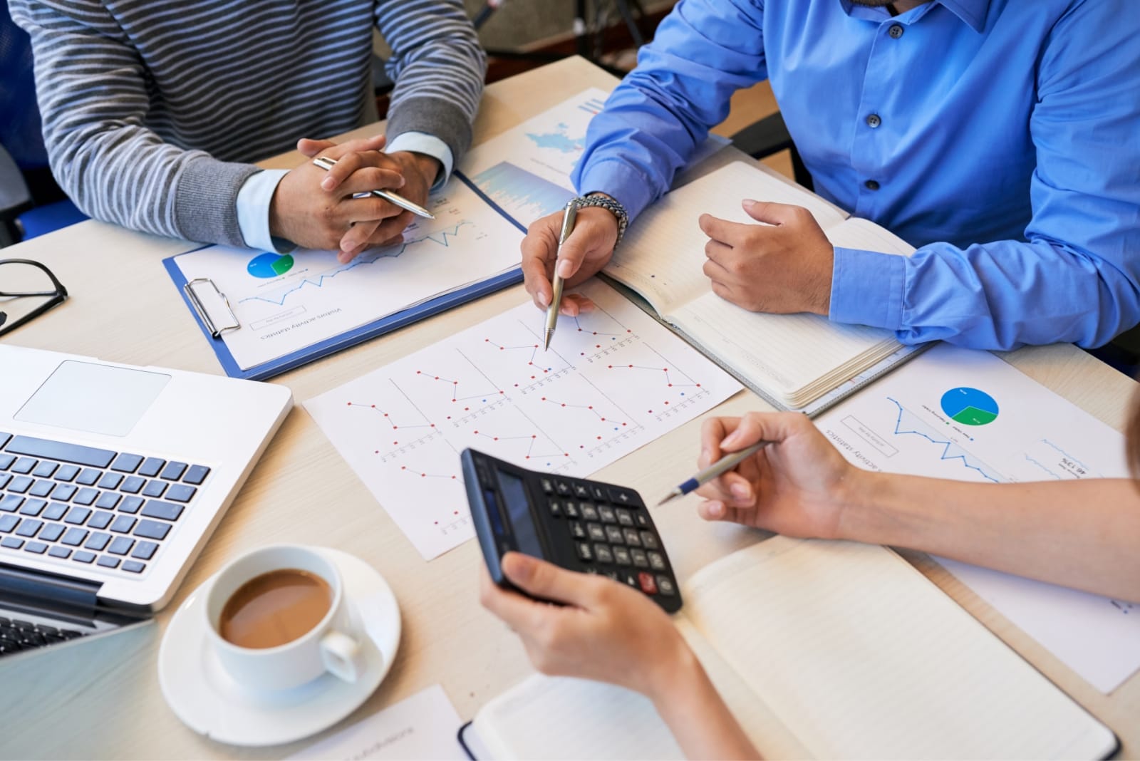 Financial analyst working on reports with a calculator